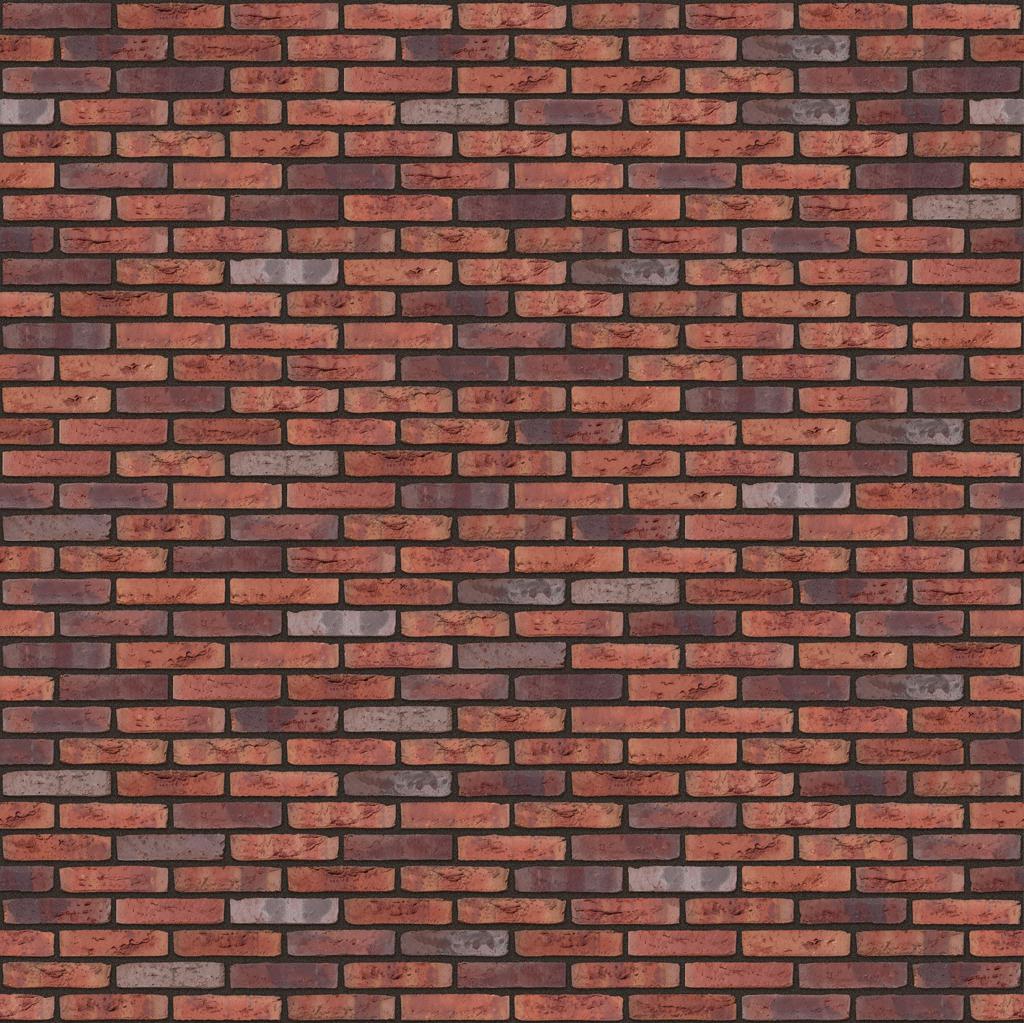 Rote Backsteinmauer mit dunklen und hellen Farbakzenten